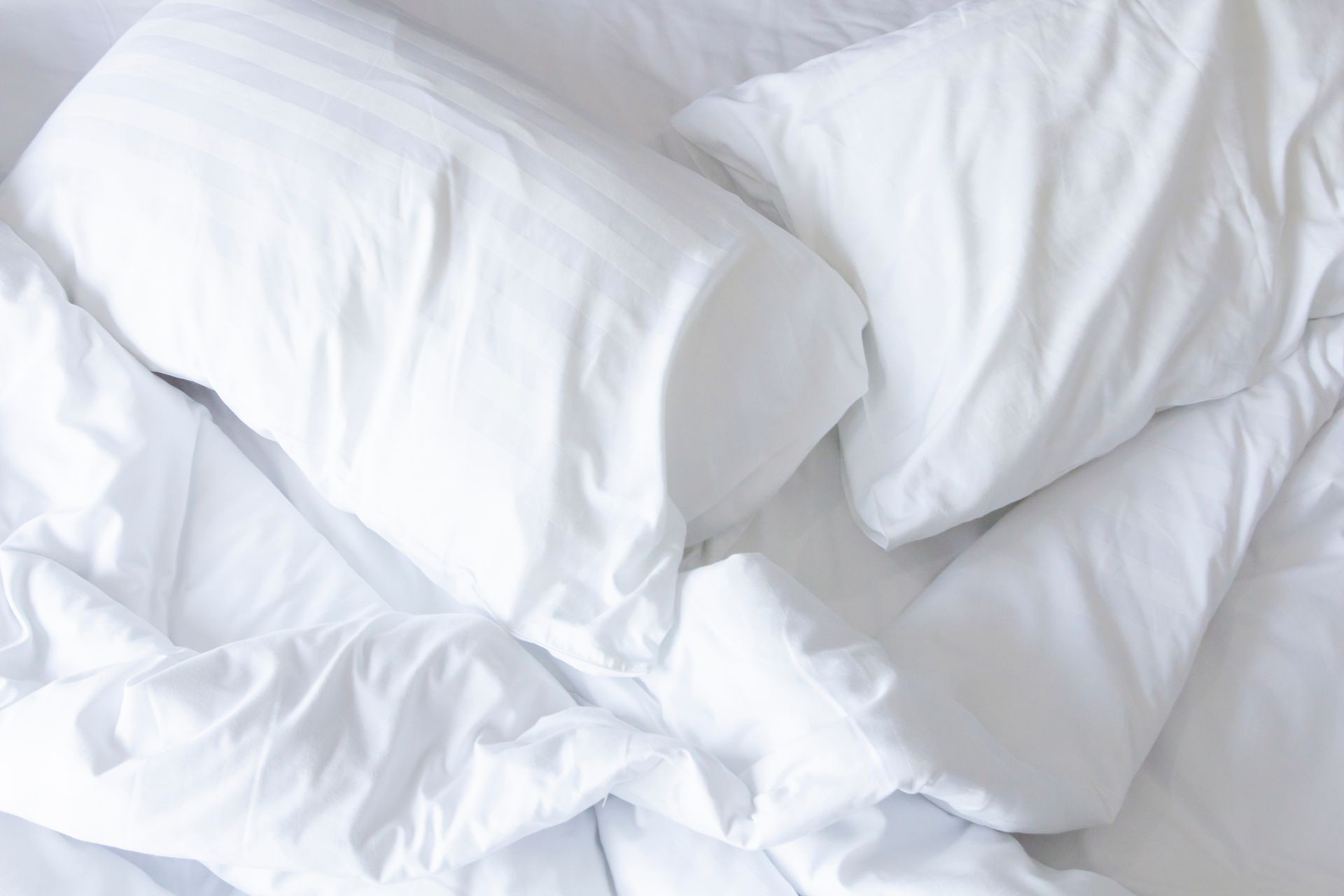 Close up white bedding sheets and pillow .